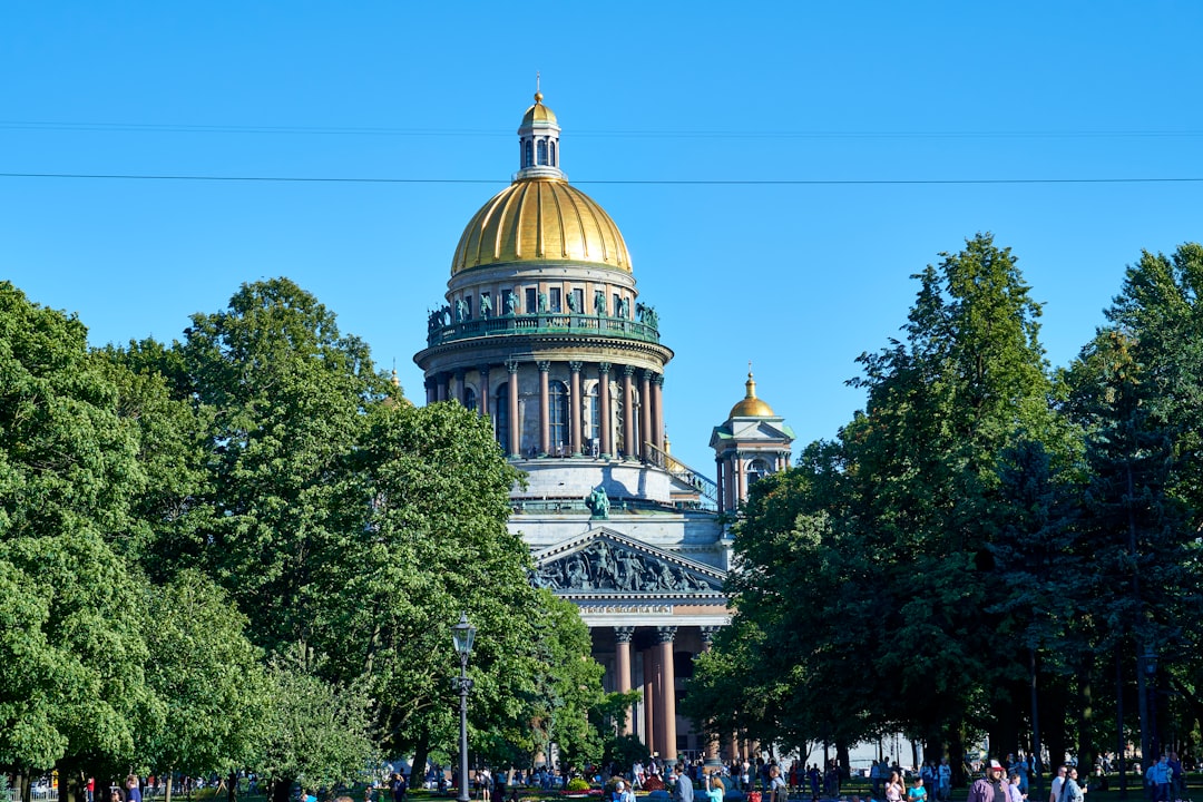 a large building with a golden dome surrounded by trees