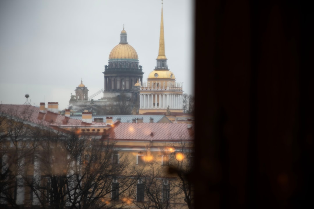 Historic buildings with golden domes under cloudy sky